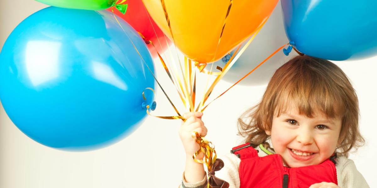 small girl with party balloons