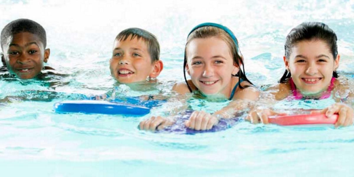 Group of children in a swimming lesson
