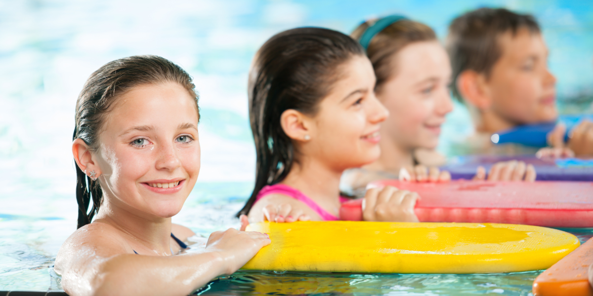 Group of children in a swimming lesson