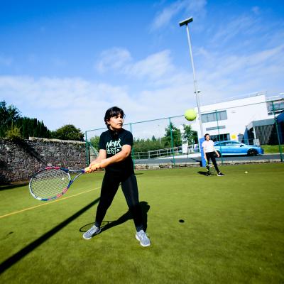 Girl playing Tennis outdoors at Comber Leisure Centre